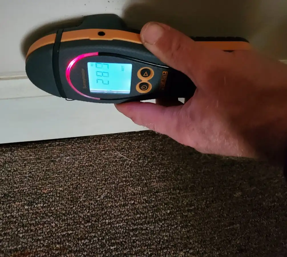 Moisture detection at baseboard during Storm Damage Restoration in Garden City